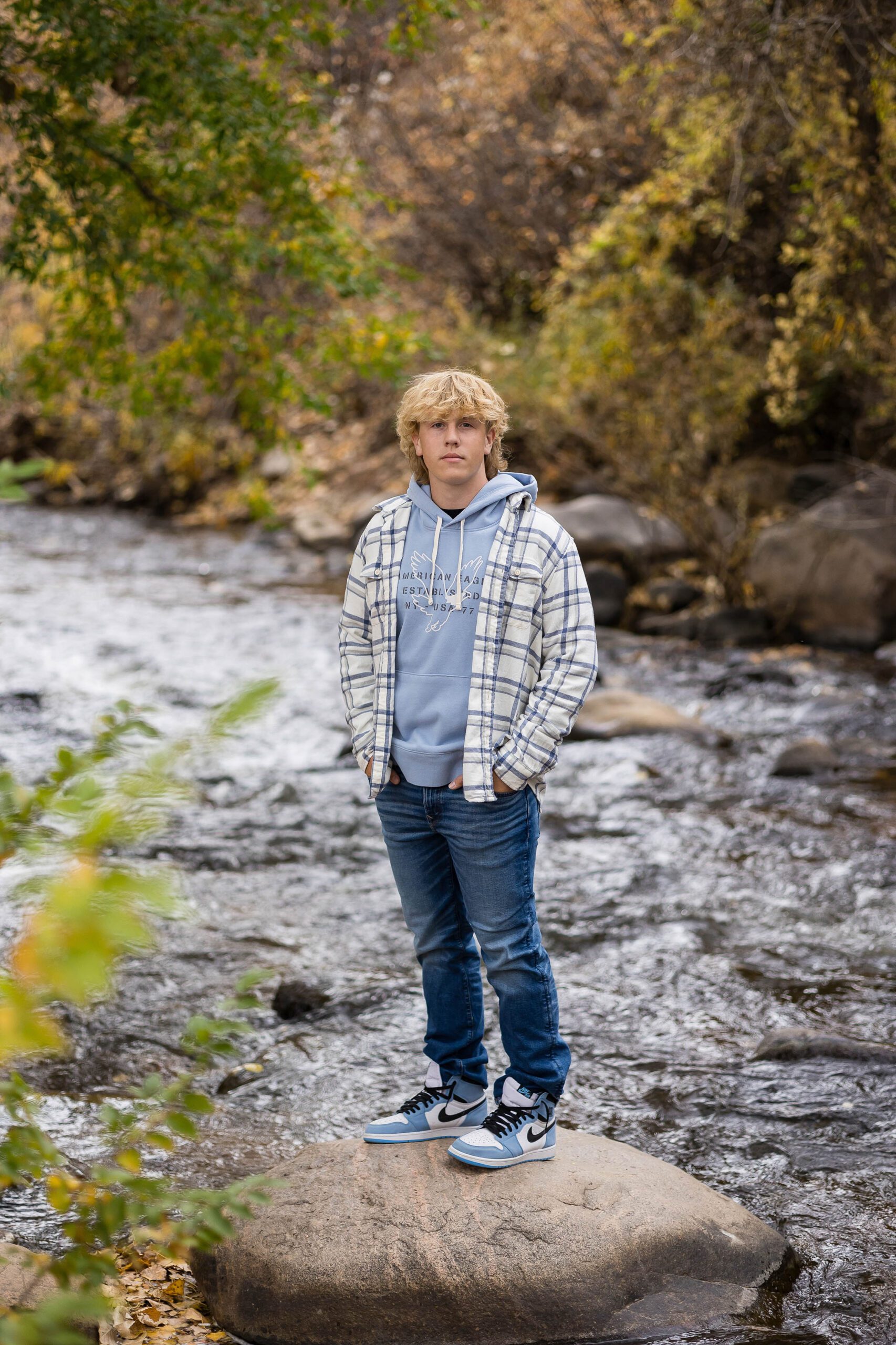 Layered flannel and hoodie outfit idea for fall senior pictures