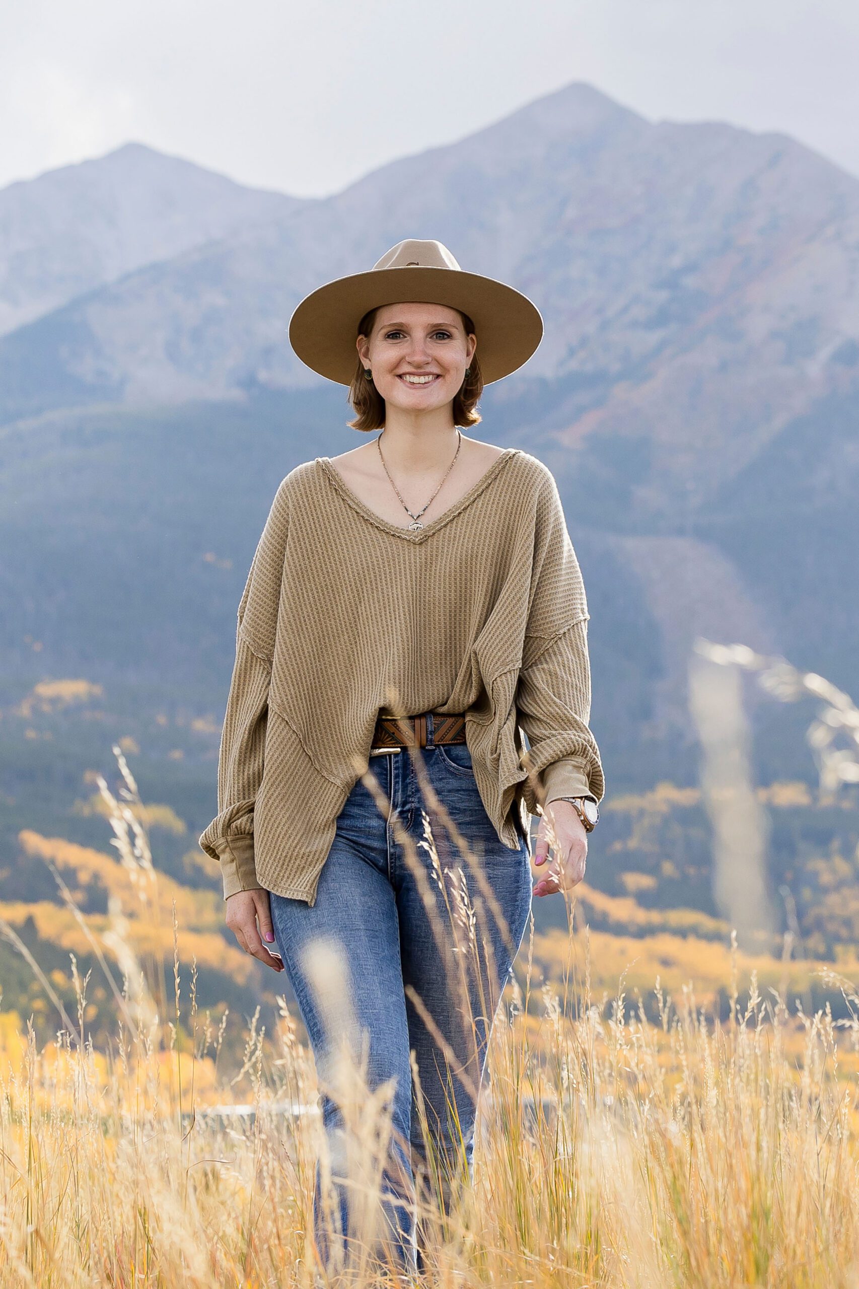 Senior wearing a wide brimmed hat for fall photo session