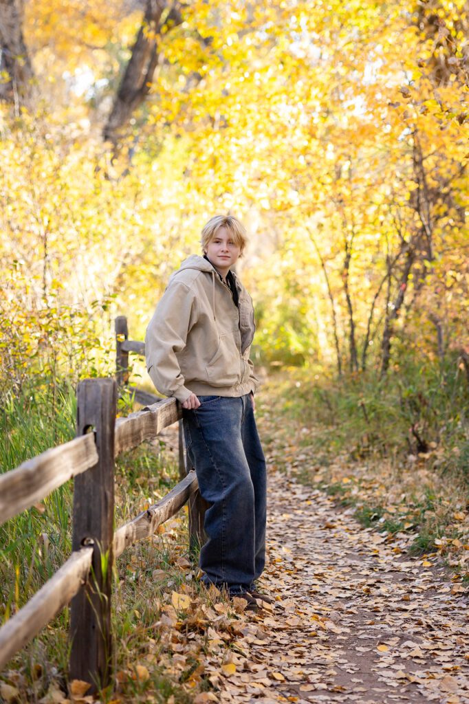 Senior wearing a wide Carhart coat for fall photo session in Morrison Colorado