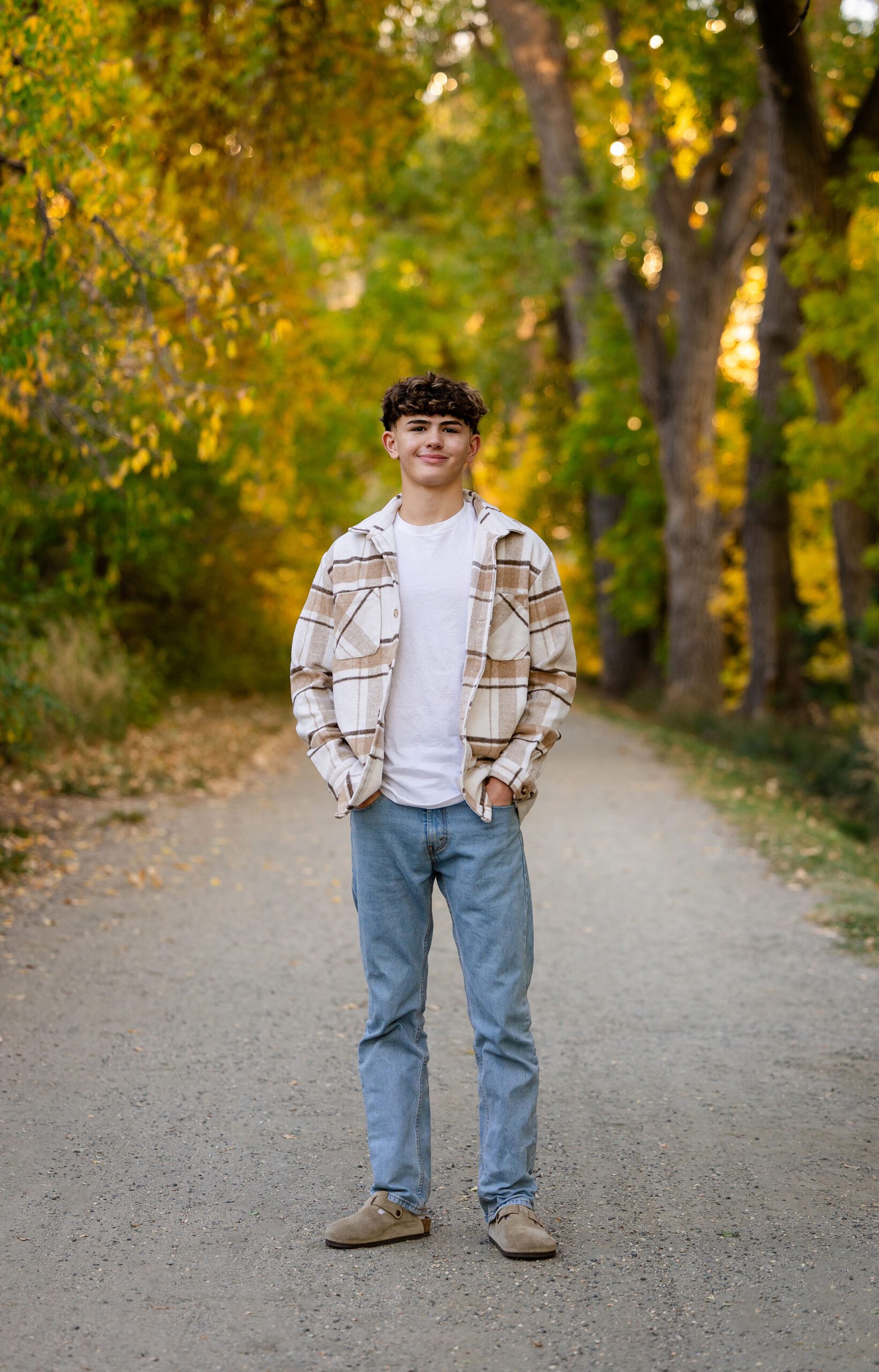 High school senior guy in flannel and jeans for fall photo session