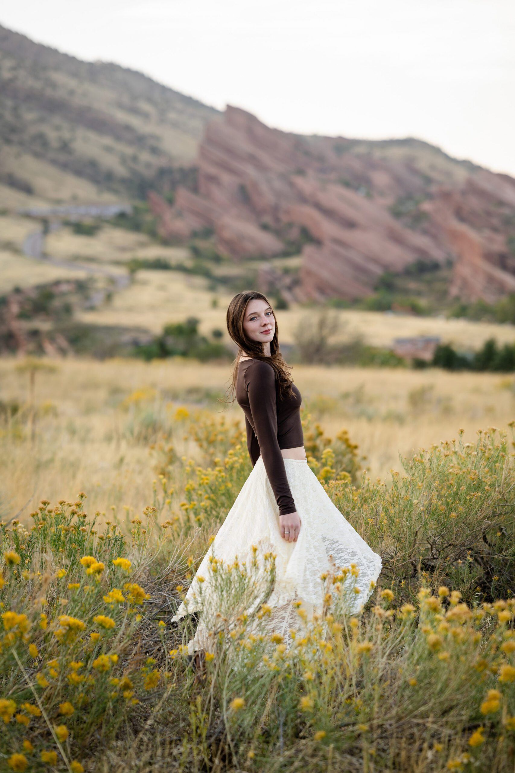 Senior in a long flowy skirt catching movement in a fall photo session